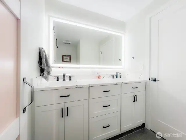Bathroom with heated mirrors and towel rack