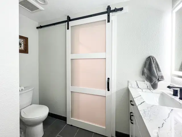 Bathroom with entry from primary bedroom and hallway