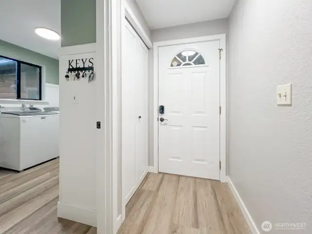 Front door from the inside, entry to the garage through the utility room