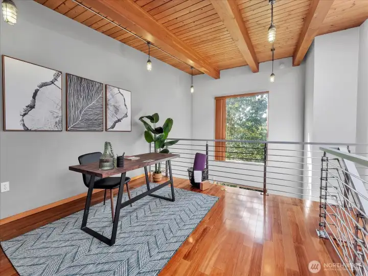 The natural wood beams and tree view gives this loft space a rustic feel