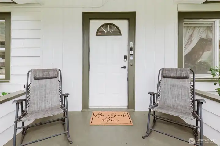 Step onto the covered front porch, framed by two blooming hydrangeas ~ imagine relaxing evenings in your rocking chairs.