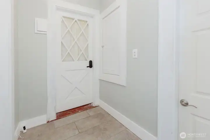 A mud room off the backyard and leading to the kitchen, keeps things neat and tidy. Looking at the back door from the kitchen area, the door to the right leads to the laundry room and the door to the left leads to the basement.