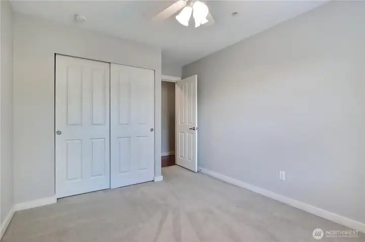 Second bedroom with ceiling fan.