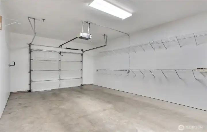 Spacious garage with additional storage space at front end of the garage. Lots of shelving.