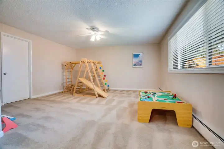 Go through the interior French Doors from the living room into this big bonus room. Notice the door on the left into a large storage space.