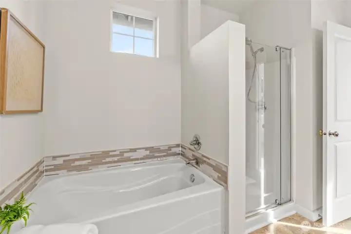 Large soaker tub with tile accents.