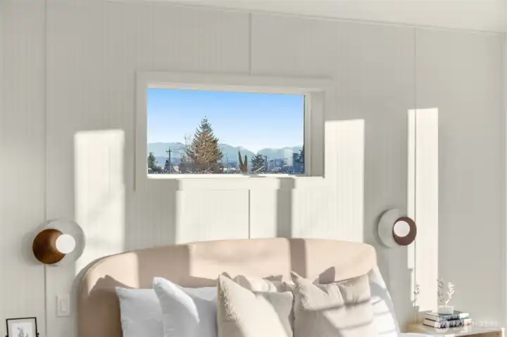 Primary suite detail highlighting clean architectural lines and a view of the outdoors.