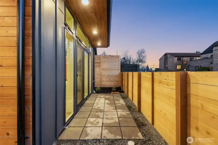 Private, fenced-in side patio area perfect for low-maintenance outdoor relaxation.