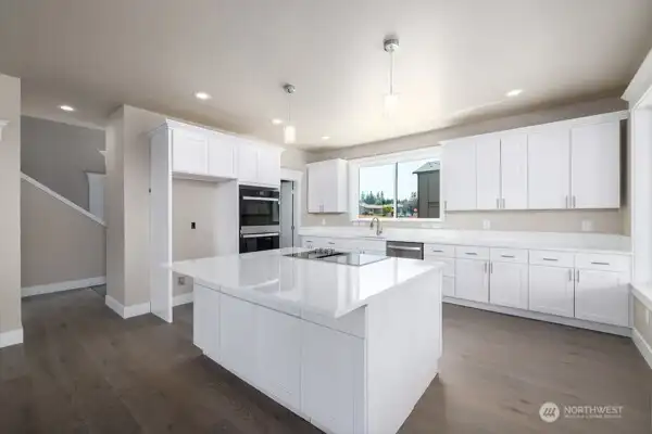 KItchen with double oven Jenn Aire Cooktop, quartz counters