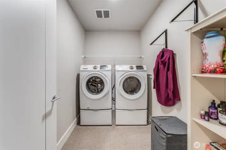 Utility room with washer and dryer upstairs