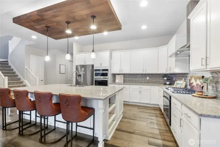 The architectural ceiling detail with accent lighting creates a warm and elevated feel.