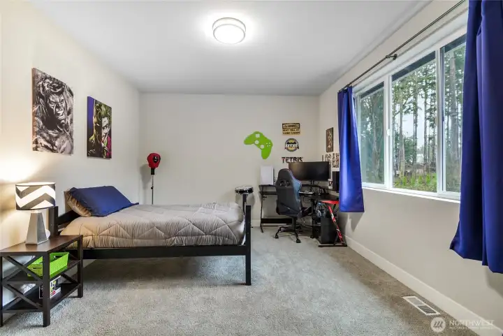 This bedroom is private and has a view of the backyard.