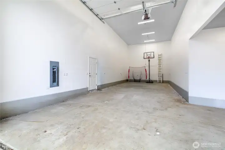 One of the home's standout features is the extra-deep RV garage with RV hookups and flexible use potential for hobbyists, car enthusiasts, or indoor recreation space. In total, the property offers six covered parking spaces along with thoughtful upgrades including hot and cold hose bibs, dedicated refrigeration outlets, generator pre-wiring, tankless water heater, and energy-efficient dual-fuel HVAC system. This space is  extra-deep  and is designed to accommodate larger recreational vehicles.  It has RV power hookups,ceiling height capable of accommodating a car lift. Could also function as indoor sports court / activity space (potentially could be easily converted into additional living space).