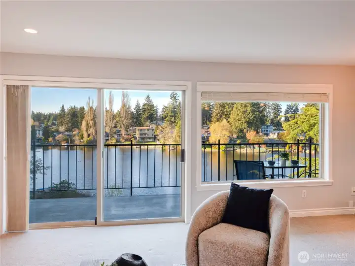 Wall-to-ceiling windows frame a stunning, ever-changing water view, filling the home with natural light and a seamless connection to your private lakeside oasis.