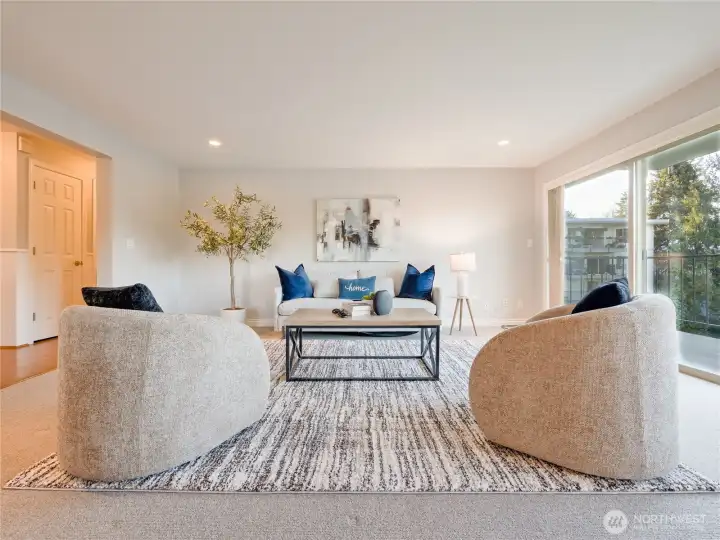 A bright, inviting living room sets the stage for effortless gatherings, with sweeping water views enjoyed from every angle.