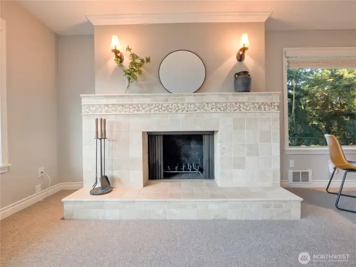 A designer-tiled fireplace serves as the sophisticated heart of your home, perfect for cozying up on crisp Seattle evenings.