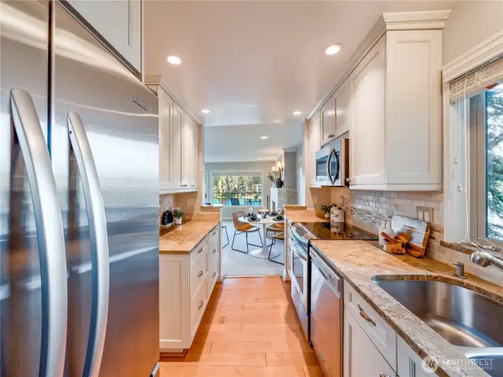 The chef’s kitchen features premium stainless steel appliances and wrap-around granite counters, designed for both daily life and high-end hosting.