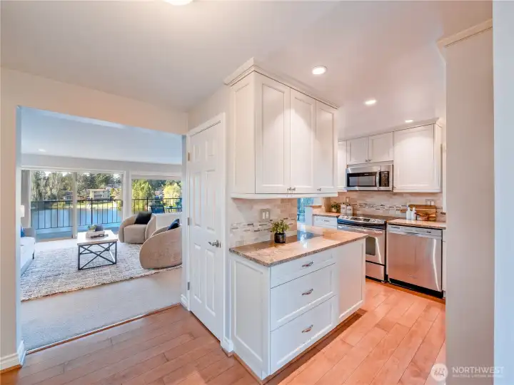 The open-concept design flows seamlessly from a fully remodeled, clean-lined kitchen into the living area, creating a highly functional and effortlessly connected space ideal for everyday living and entertaining.