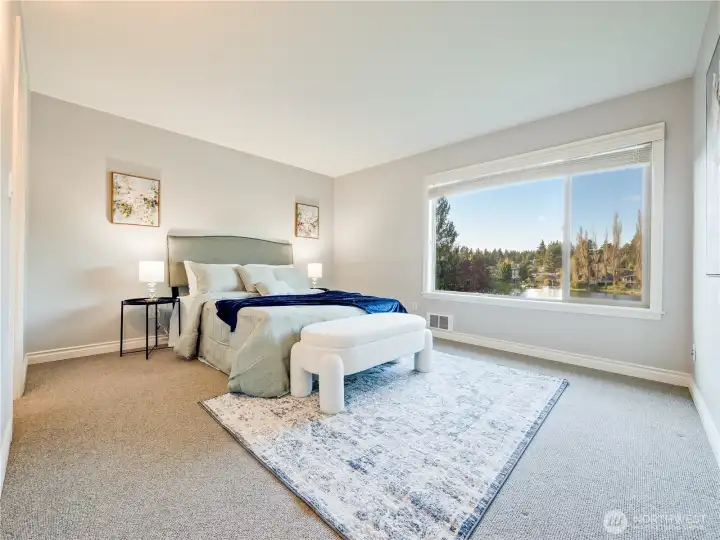 Wake to tranquil lake views in a primary suite designed for comfort, privacy, and everyday escape.