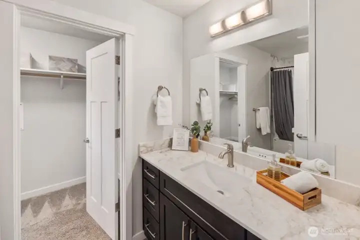 Primary bath has modern finishes and walk-in closet