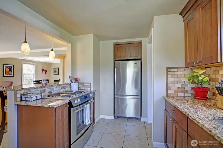 View of the kitchen from the sink, looking out into the home.