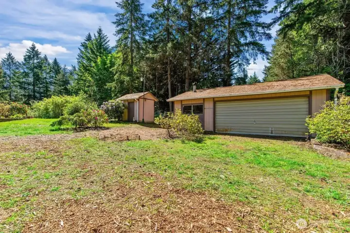 Garage with workshop space and pump house