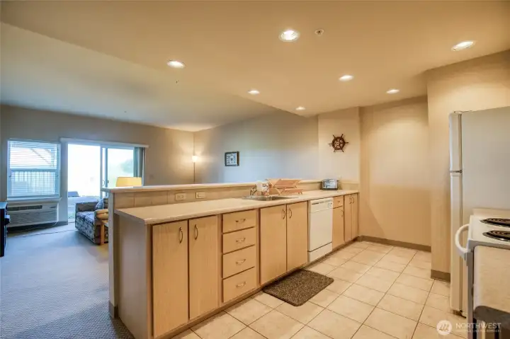 Galley style kitchen with tiled floor and eating bar. Galley style kitchen with tiled floor and eating bar.