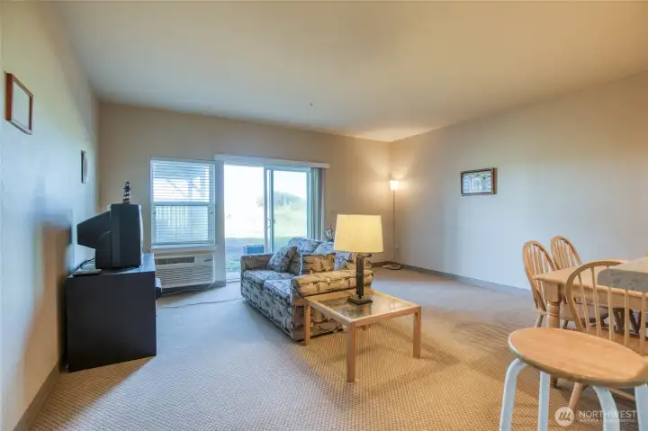 Spacious living room leading directly to patio is steps away from sand dunes. Spacious living room leading directly to patio is steps away from sand dunes.