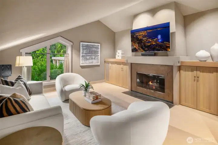 A separate family room on this level offers a more intimate counterpoint to the expansive great room. Anchored by the home’s second fireplace and surrounded by custom built-ins, the space provides a warm and inviting setting for conversation, reading, media, or quiet relaxation. A separate family room on this level offers a more intimate counterpoint to the expansive great room. Anchored by the home’s second fireplace and surrounded by custom built-ins, the space provides a warm and inviting setting for conversation, reading, media, or quiet relaxation.
