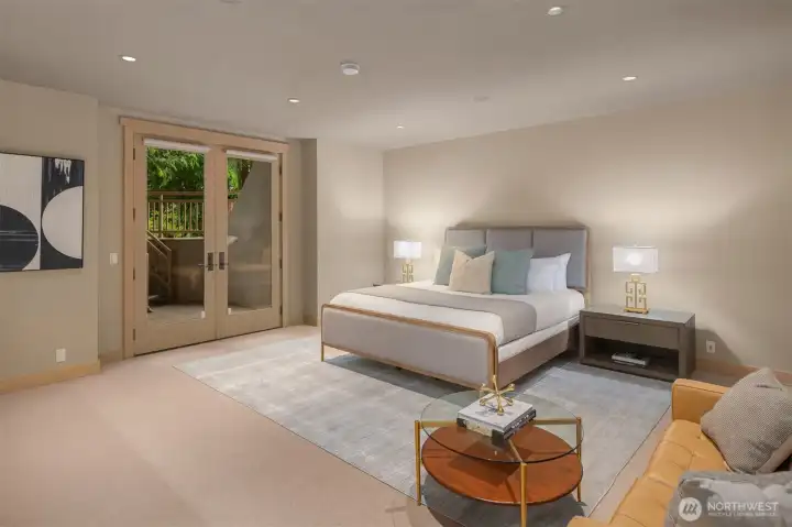 A spacious guest bedroom serves as a private retreat, offering a meaningful degree of separation from the home’s primary bedroom and living spaces. A separate exterior entry and direct access to a private patio further enhance the sense of independence while extending the home’s connection to the peaceful setting and surrounding landscape. Nearby, a built-in wet bar with a sink and substantial counter space serves as a convenient refreshment and hospitality area, ideal for morning coffee, beverages, and light serving needs. The room’s scale and flexibility also make it well suited for use as an additional media room, recreation space, fitness area, or private office when guests are not in residence. Extensive storage areas provide practical utility rarely found in modern homes of any size. A spacious guest bedroom serves as a private retreat, offering a meaningful degree of separation from the home’s primary bedroom and living spaces. A separate exterior entry and direct access to a private patio further enhance the sense of independence while extending the home’s connection to the peaceful setting and surrounding landscape. Nearby, a built-in wet bar with a sink and substantial counter space serves as a convenient refreshment and hospitality area, ideal for morning coffee, beverages, and light serving needs. The room’s scale and flexibility also make it well suited for use as an additional media room, recreation space, fitness area, or private office when guests are not in residence. Extensive storage areas provide practical utility rarely found in modern homes of any size.