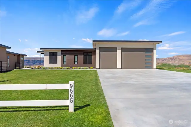 This stunning modern architecture home features an extremely large driveway and an oversized 3-car garage with 12' high doors - thoughtfully designed to store all kinds of toys and gear.