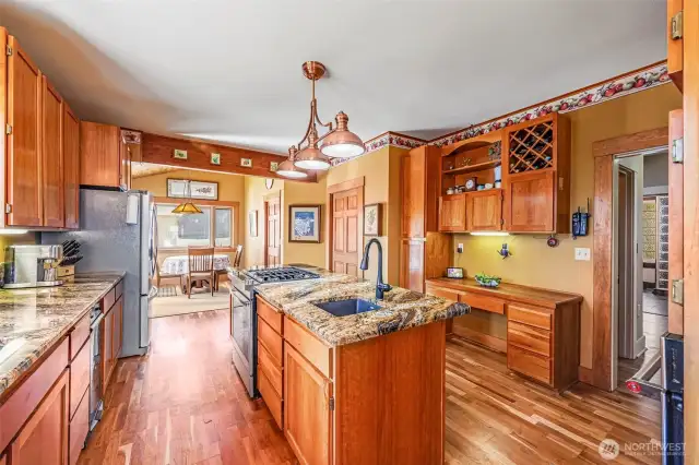 This updated kitchen also includes an extra work sink, a trash compactor, and a gas stove, offering enhanced functionality and convenience for cooking and cleaning. These thoughtful additions make this kitchen both practical and efficient.