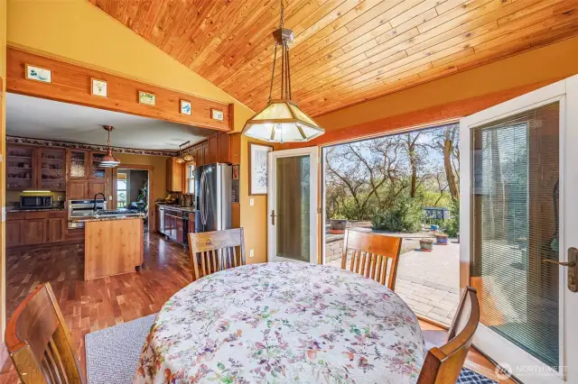 This spacious kitchen features a work desk, pantry, and a cozy eating area that leads out to the back paved patio—perfect for enjoying meals and outdoor living. Recent updates include granite countertops, new floors, and custom cabinetry, creating a functional and stylish space.