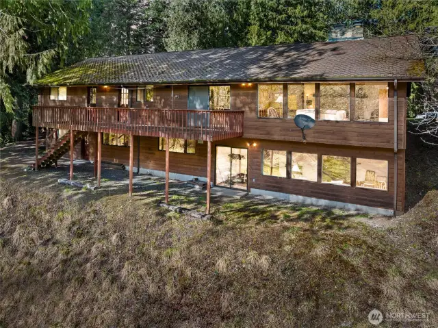 The back of the house has a very large deck that runs from the living/dining area to the kitchen--perfect for all your outdoor entertaining, viewing, and relaxing needs.