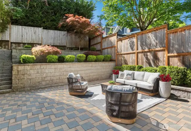 Stone patio + terraced gardens make outdoor living a dream.