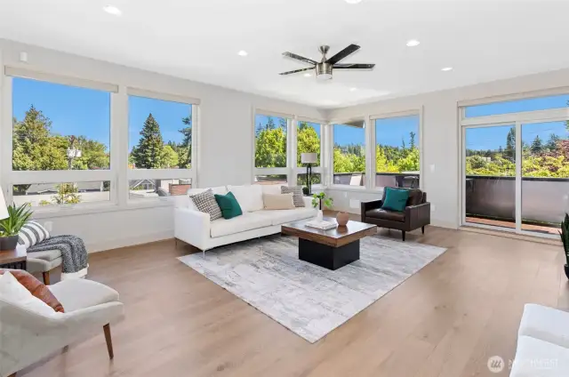 Upper-level living room opens to patio—soaked in natural light.