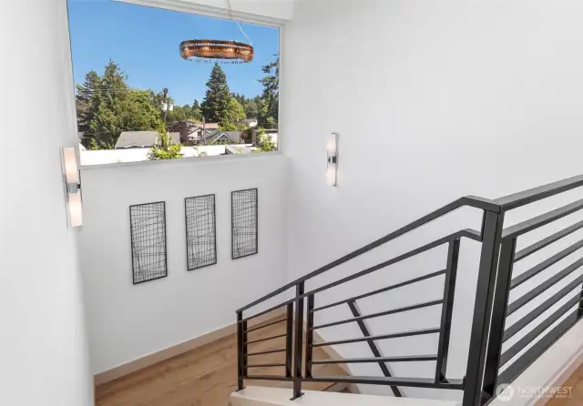 Sleek staircase frames picture-perfect mountain and territorial views.