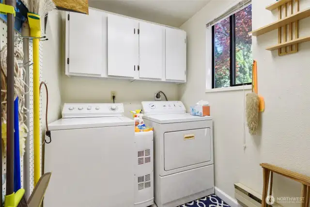 Large laundry room with washer and dryer and plenty of storage.