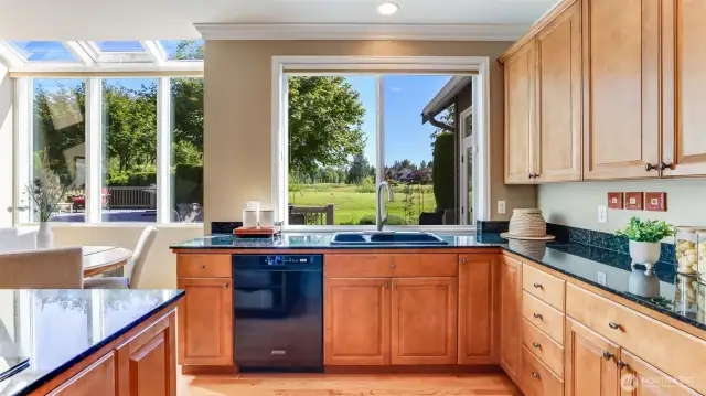 Granite counters, double ovens, gas cooktop and an abundance of handsome cabinetry