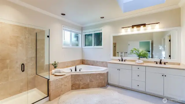 Remodeled primary bath with frameless glass shower, soaking tub w/designer tile surround and heated floors