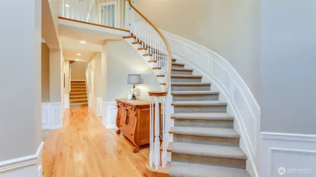 Grand two-story entry is highlighted by the curved staircase and art niche