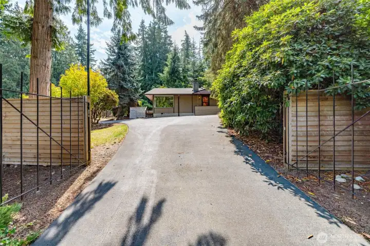 The main gate to the driveway off Comanche Dr. There is a flagpole just to the left of the driveway.