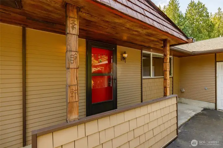 The front entry with newer screen door for ventilation on hot days.