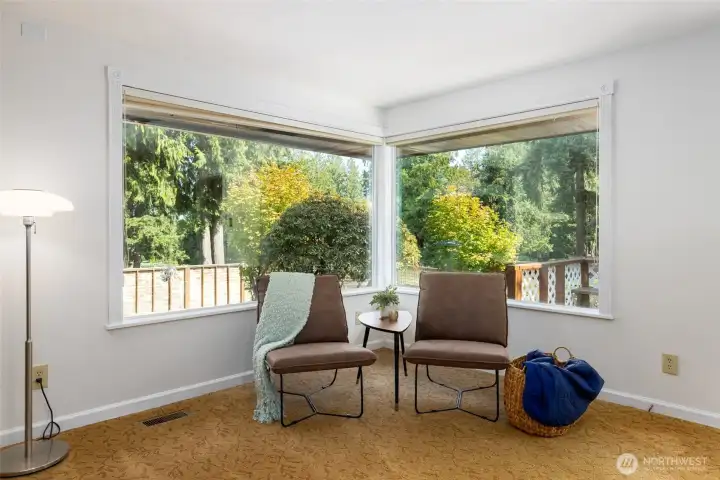 Big front windows look out onto the green and spacious yard. Blinds in the windows for privacy if you want it.