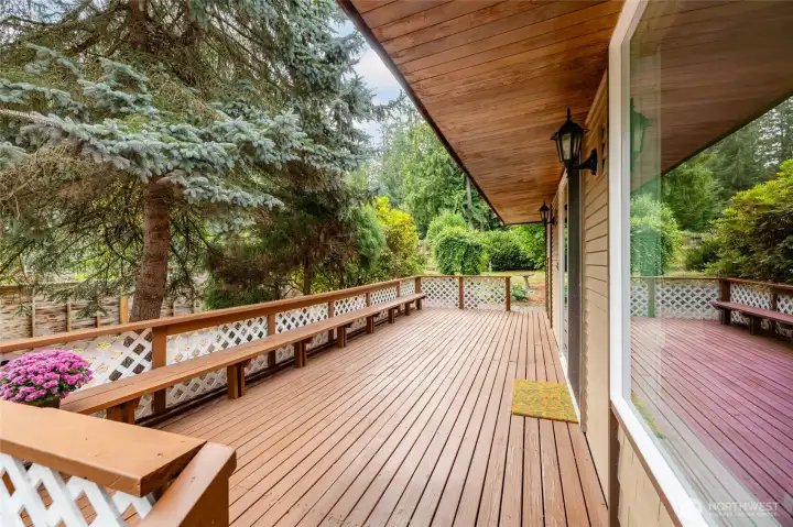 A large deck with built in seating on the east side of the house catches morning light.