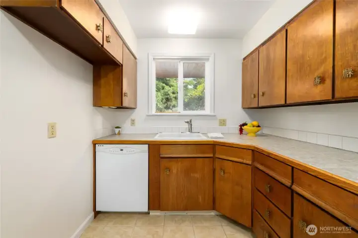 Ample cabinet space for storage and room for a butcherblock island on the left.