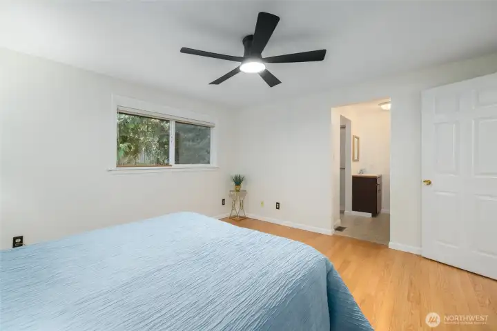 Adjoining the primary bedroom is a small bathroom with a shower stall and a walk-in closet.