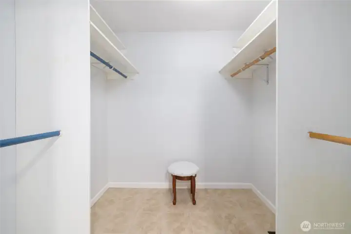 The walk-in closet with tile floor.