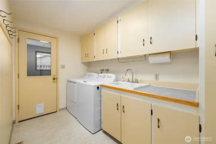 Very useful and practical laundry room with access to the garage. Deep utility sink and lots of storage. The newer washer and dryer go with the house.