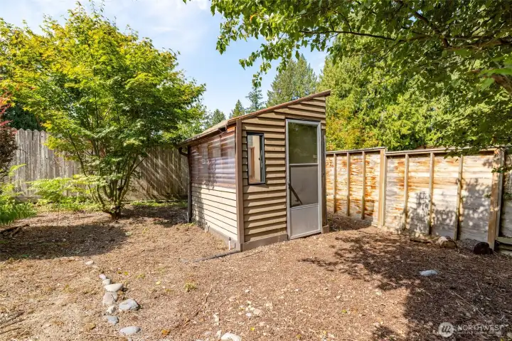 In the yard, is a cute little garden shed for planting starts.